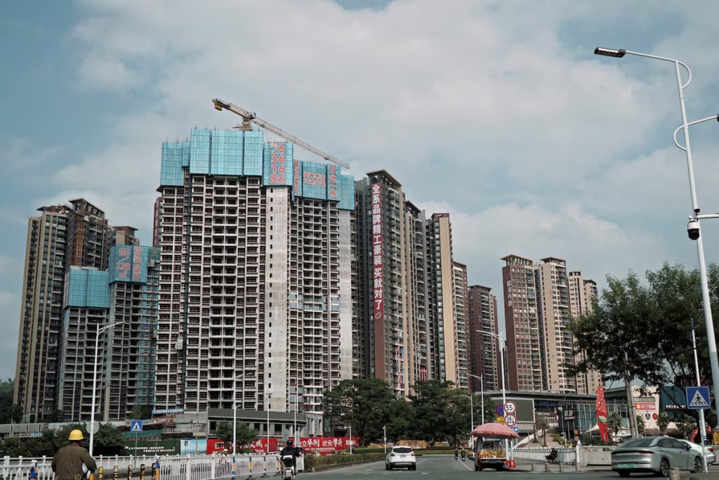 Sale signs adorn residential buildings under construction in Huizhou, Guangdong province, China. REUTERS