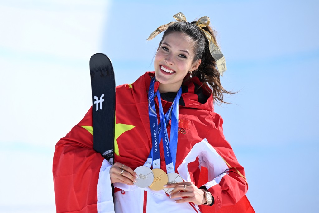 Gold medallist China's Gu Ailing Eileen celebrates on the podium after winning the freestyle skiing women's freeski halfpipe final during the Milano Cortina 2026 Winter Olympic Games at Livigno Snow Park, in Livigno (Valtellina), on February 22, 2026. (AFP)