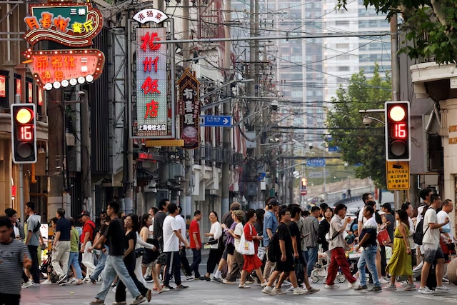 People walk past a lane lined up with restaurants, at a shopping area in Shanghai, China September 28, 2024. (Reuters)