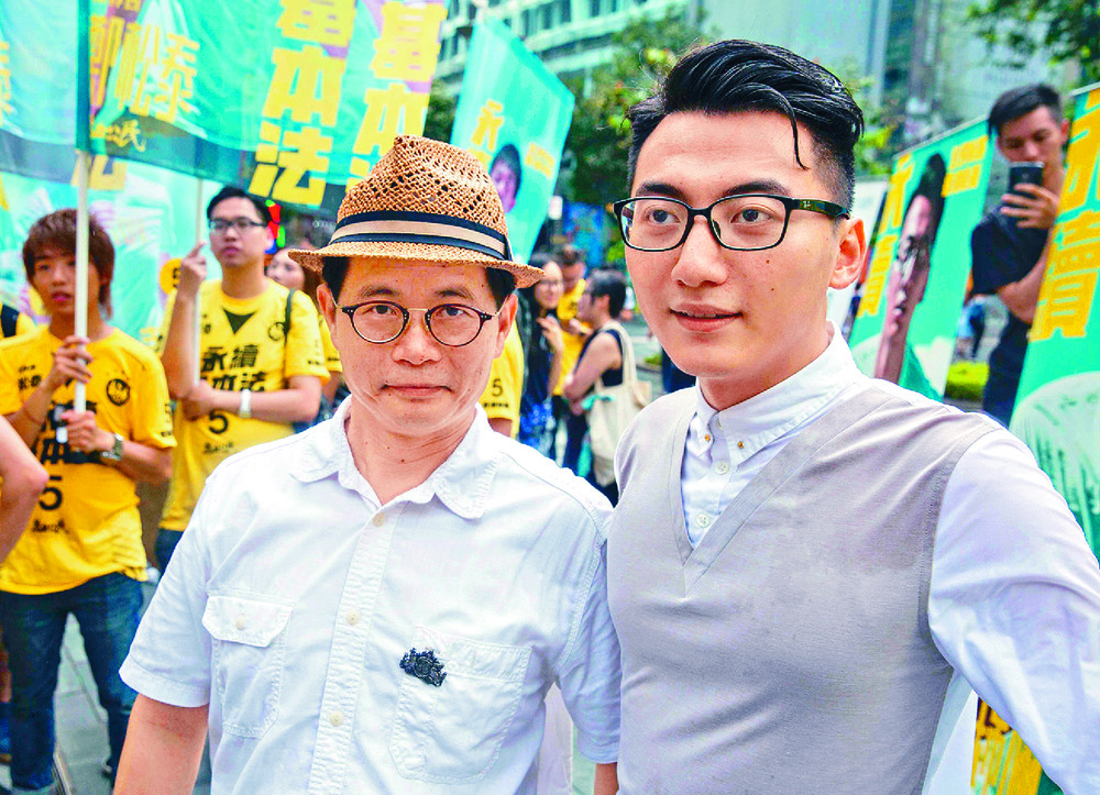 Horace Chin, far left, seen with activist Alvin Cheng, said the death of the husband of Chuang Shuk-kwan was good news. AFP, SING TAO Horace Chin, far left, seen with activist Alvin Cheng, said the death of the husband of Chuang Shuk-kwan was good news. AFP, SING TAO
