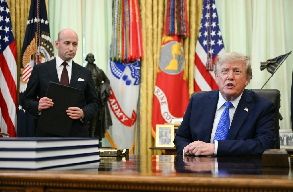 CORRECTION / White House Deputy Chief of Staff Stephen Miller (L) holds an executive order on birthright citizenship as US President Donald Trump speaks before signing it in the Oval Office of the White House in Washington, DC, on August 6, 2026. (Photo by Jim WATSON / AFP)