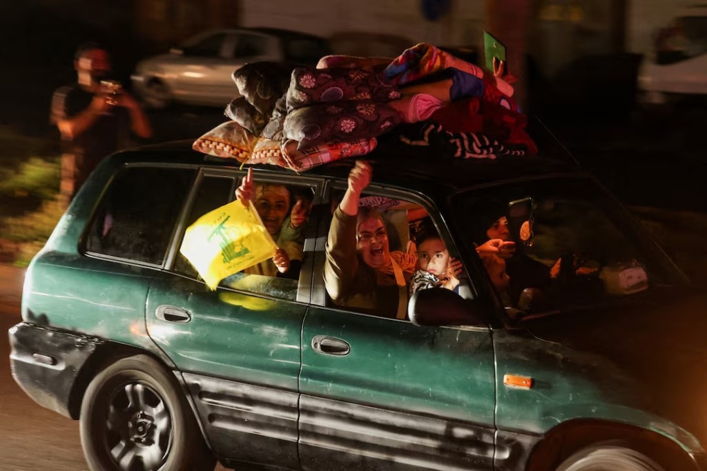 Displaced people react as they return to their homes in a vehicle carrying belongings on its roof after a 10-day ceasefire between Lebanon and Israel went into effect, in Sidon, Lebanon, April 17, 2026. REUTERS/Aziz Taher