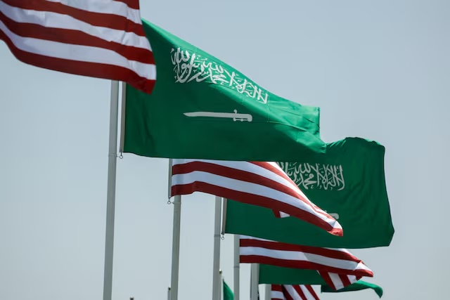 U.S. and Saudi flags flutter along a highway of Riyadh, as pictured through the glass of a car, ahead of the arrival of U.S. President Donald Trump to Riyadh, Saudi Arabia May 12, 2025. REUTERS/Hamad I Mohammed/File Photo