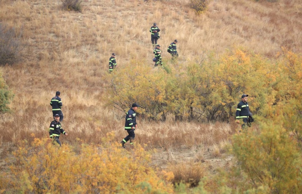  Members of emergency services inspect the area at the site of the Turkish C-130 military cargo plane crash near the Azerbaijani border, in Sighnaghi municipality, Georgia, November 12, 2025. REUTERS/Irakli Gedenidze