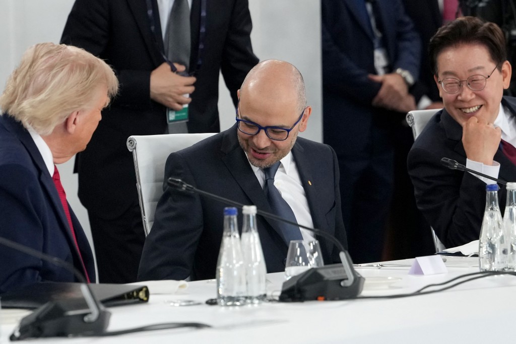 Photo by JULIA DEMAREE NIKHINSON / POOL / AFP US President Donald Trump (L), Google DeepMind Demis Hassabis (C) and South Korea's President Lee Jae-myung react during a working lunch meeting of G7 members, partner countries, and artificial intelligence business leaders as part of the G7 summit, in Evian, eastern France, on June 17, 2026.
