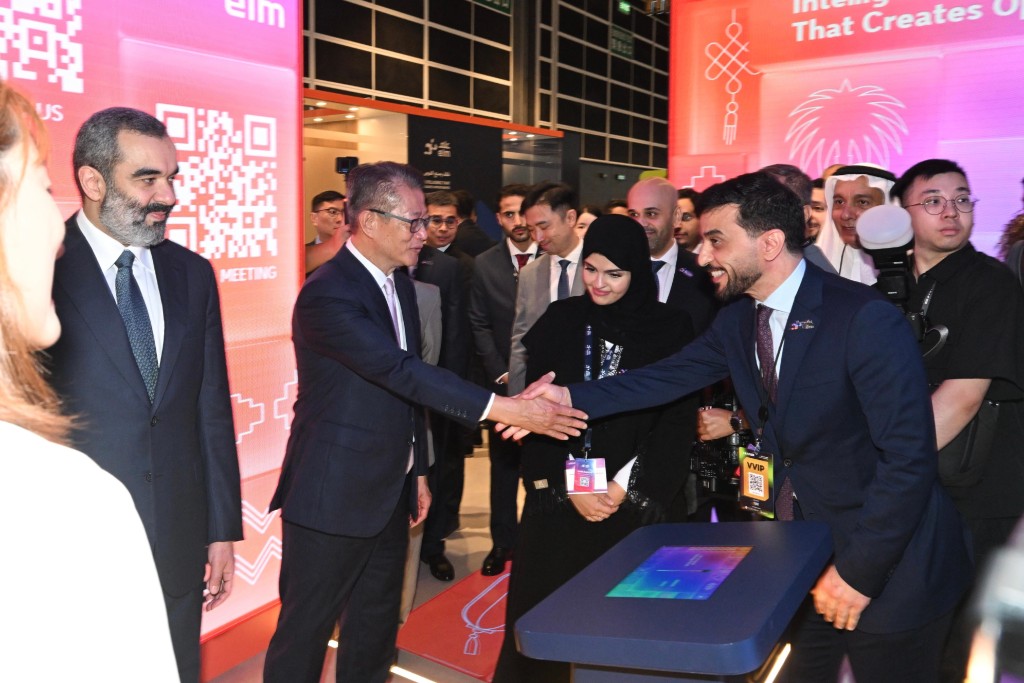 Paul Chan (second left), touring an exhibition booth at the LEAP East 2026 opening ceremony on Wednesday. ISD