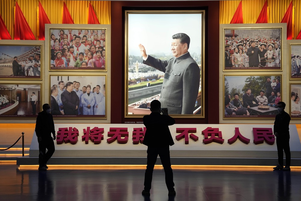 A portrait of Chinese President Xi Jinping is displayed near the words that means 'I will put aside my own well-being for the good of my People' at the Museum of the Communist Party of China in Beijing, Wednesday, Oct. 12, 2022. (AP) A portrait of Chinese President Xi Jinping is displayed near the words that means 'I will put aside my own well-being for the good of my People' at the Museum of the Communist Party of China in Beijing, Wednesday, Oct. 12, 2022. (AP)