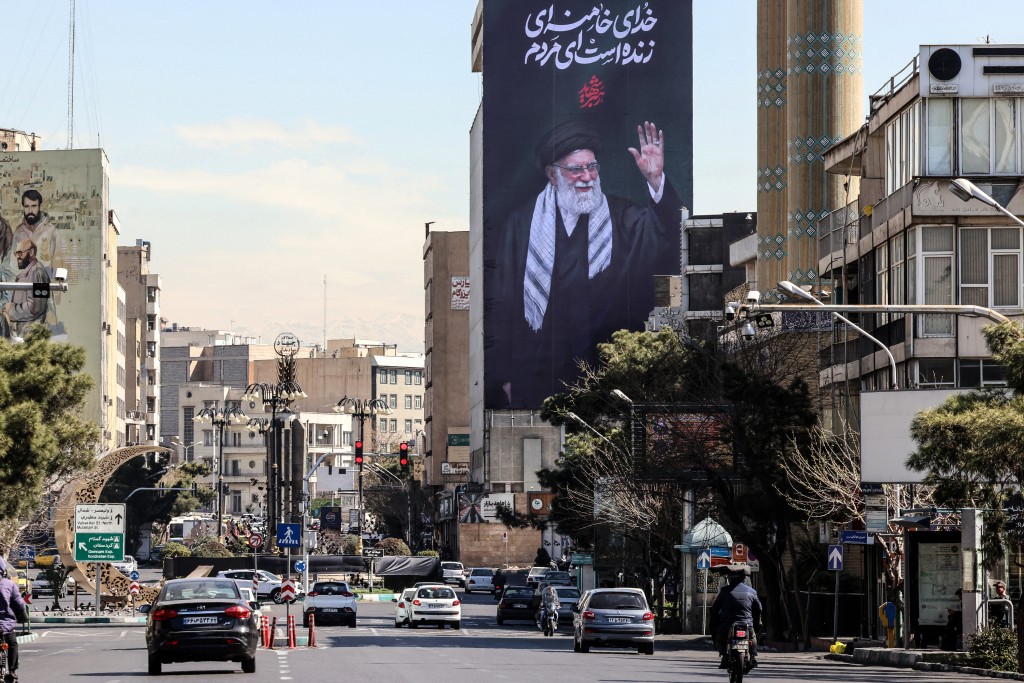 A large billboard of Iran’s slain supreme leader Ayatollah Ali Khamenei reading in Persian "His God is still alive" in Tehran on March 3, 2026. (AFP)