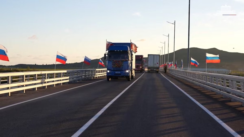 Trucks drive along a road during a ceremony opening the first road bridge between Russia and North Korea across the Tumen River, locally known as Tumannaya, on the border with North Korea in the Primorsky region, Russia, September 7, 2026, in this still image taken from a video. Russian Government/Handout via REUTERS