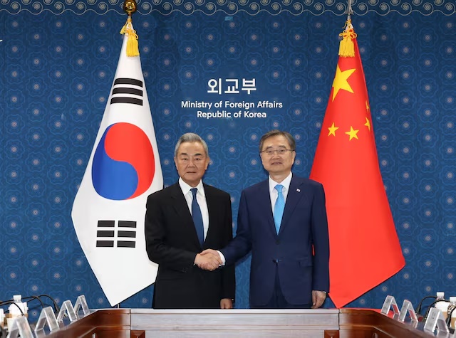 Chinese Foreign Minister Wang Yi shakes hands with his South Korean counterpart Cho Hyun during their meeting at the Foreign Ministry in Seoul, South Korea, August 19, 2026. Yonhap via REUTERS