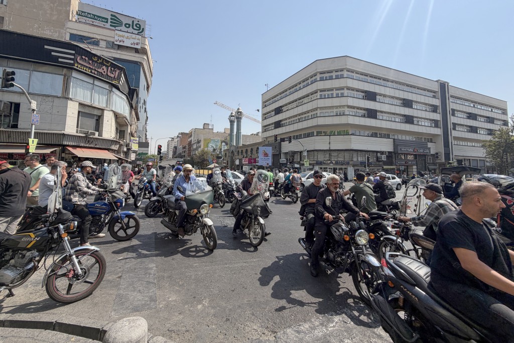 Iranian motorists ride along a street in Tehran on September 27, 2026.  (AFP)