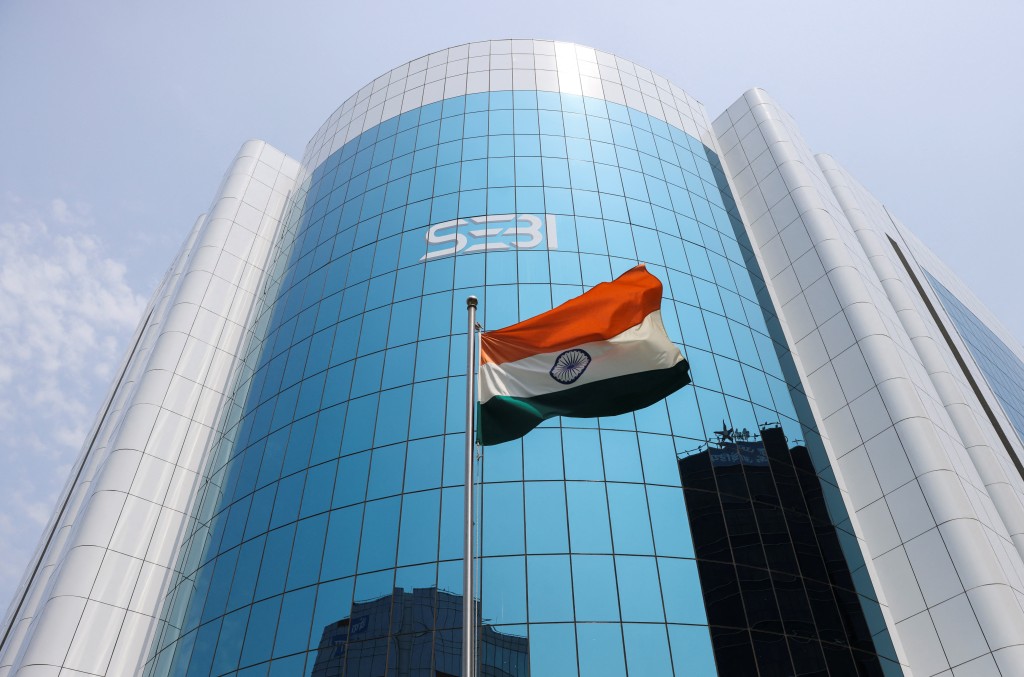 The Indian flag flies in front of the new logo of the Securities and Exchange Board of India (SEBI) at its headquarters in Mumbai, India, April 19, 2023. REUTERS