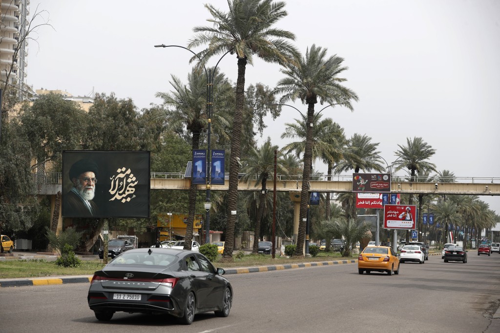 Cars drive past a billboard depicting Iran's slain supreme leader Ayatollah Ali Khamenei near the Iraqi Intelligence Directorate in the Mansour district of Baghdad on March 21, 2026. (AFP)