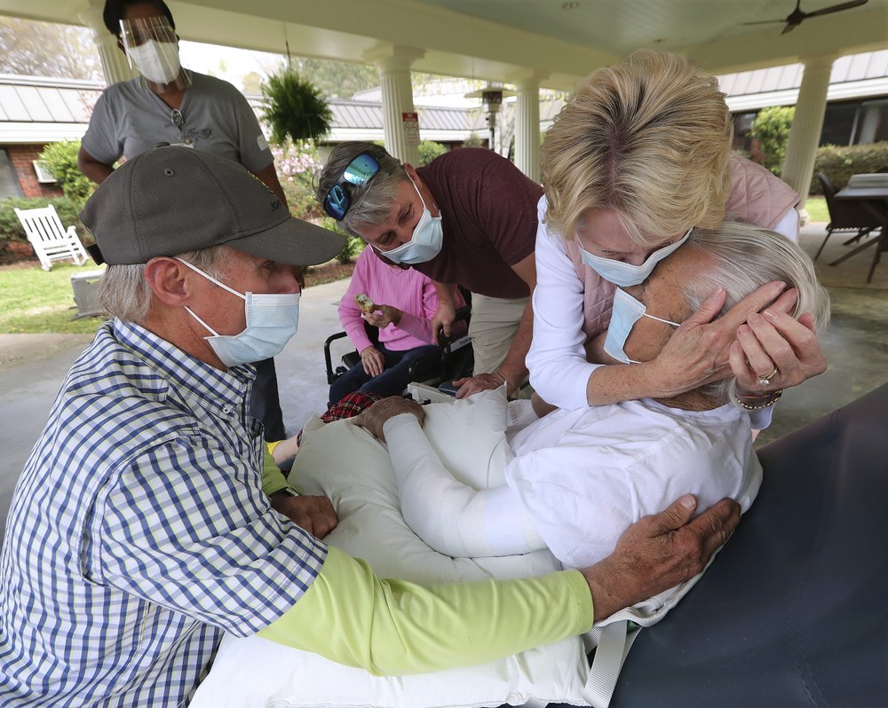 Bonnie McBrome, right, and her brother Erwin Bryan, left, emotionally embrace their father Doyle Bryan, 86, for the first time since restrictions were put in place as loved ones begin in person family visits at Westbury Medical Care and Rehab on Tuesday, March 30, 2021, in Jackson, Georgia. The facility was one of the hardest hit in Georgia losing 34 residents and a staff member. Bonnie McBrome, right, and her brother Erwin Bryan, left, emotionally embrace their father Doyle Bryan, 86, for the first time since restrictions were put in place as loved ones begin in person family visits at Westbury Medical Care and Rehab on Tuesday, March 30, 2021, in Jackson, Georgia. The facility was one of the hardest hit in Georgia losing 34 residents and a staff member.
