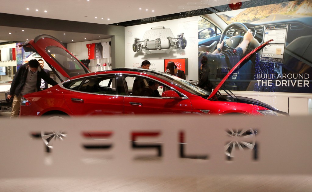 A man looks at a Tesla Model S car at its showroom in Beijing, China January 29, 2014.