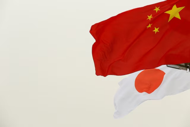 Chinese and Japanese flags flutter in front of the Tiananmen Gate in Beijing, China October 25, 2018. REUTERS/Thomas Peter