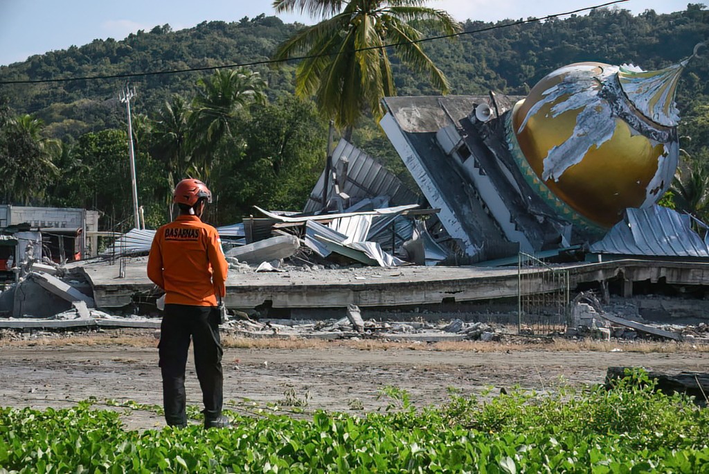 A rescuer conducting operations near a collapsed mosque following a 7.7-magnitude earthquake in Satar Kampas village, East Manggarai, East Nusa Tenggara. (AFP)