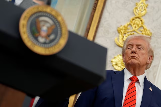 U.S. President Donald Trump listens during an announcement about lowering U.S. drug prices, at the White House in Washington, D.C., U.S., October 10, 2025. REUTERS/Kent Nishimura/File Photo