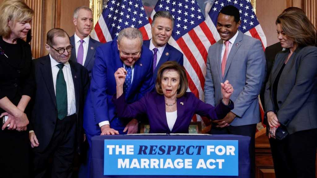 FILE PHOTO: U.S. House Speaker Nancy Pelosi signs "The Respect for Marriage Act" alongside fellow members of Congress, during a bill enrollment ceremony on Capitol Hill, in Washington, U.S., December 8, 2022. REUTERS