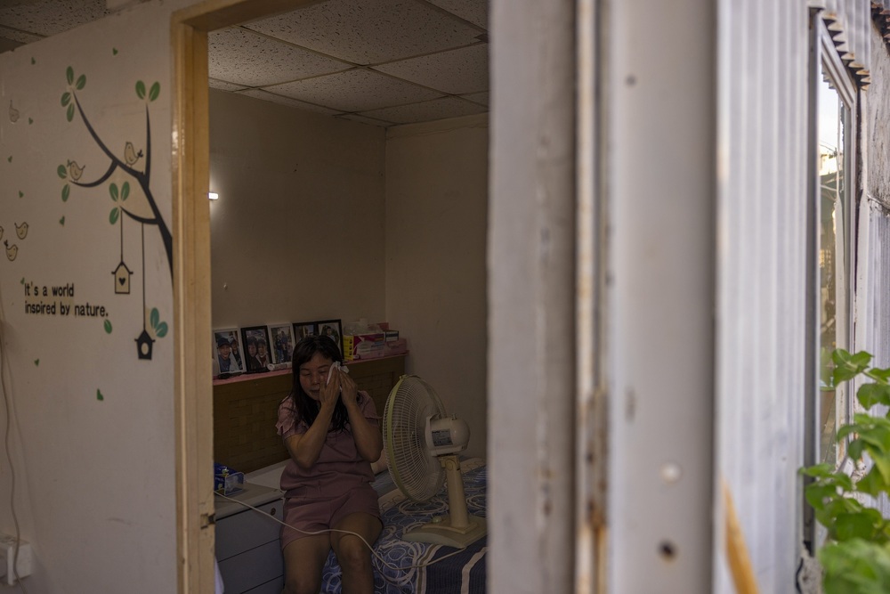 Ying wipes her sweat from her head amid the summer heat in Hong Kong, Wednesday, Aug. 9, 2023. (AP)