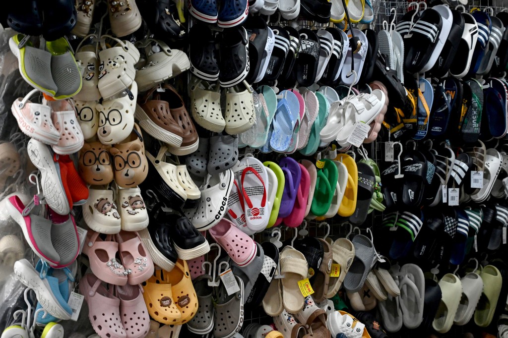 Sandals are displayed for sale at a shoe store in Hanoi's Old Quarter on July 3, 2025. Vietnam's trade deal with the United States averts the most punishing of Donald Trump's "reciprocal" levies but analysts warned it could provoke a fresh standoff between Washington and Beijing. (Photo by Nhac NGUYEN / AFP)