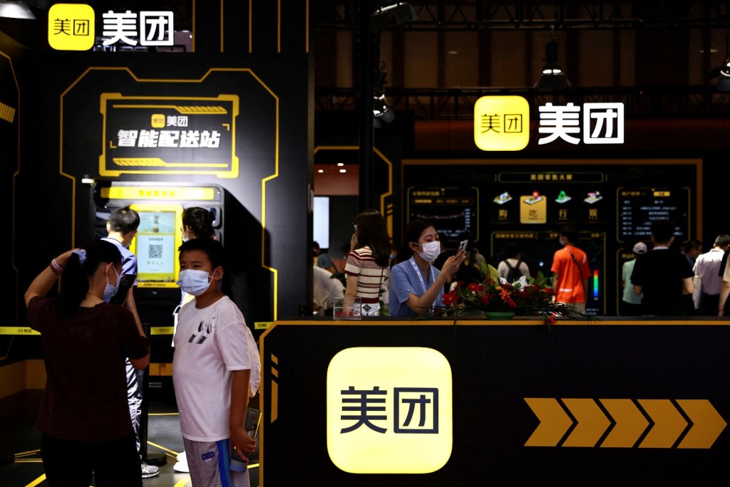 Visitors stand near a Meituan booth at the 2022 World Robot Conference in Beijing. Photo by REUTERS 