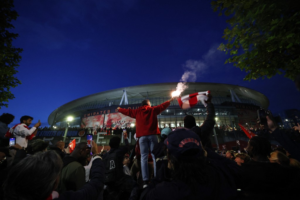 Arsenal fans celebrate outside the Emirates stadium as Arsenal win the Premier League (Reuters)