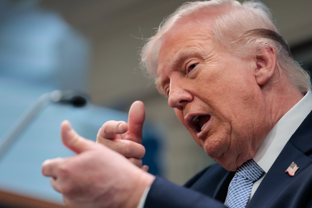US President Donald Trump mimics firing a gun as he speaks about the conflict in Iran in the James S. Brady Press Briefing Room of the White House on April 6, 2026, in Washington, DC. (AFP)