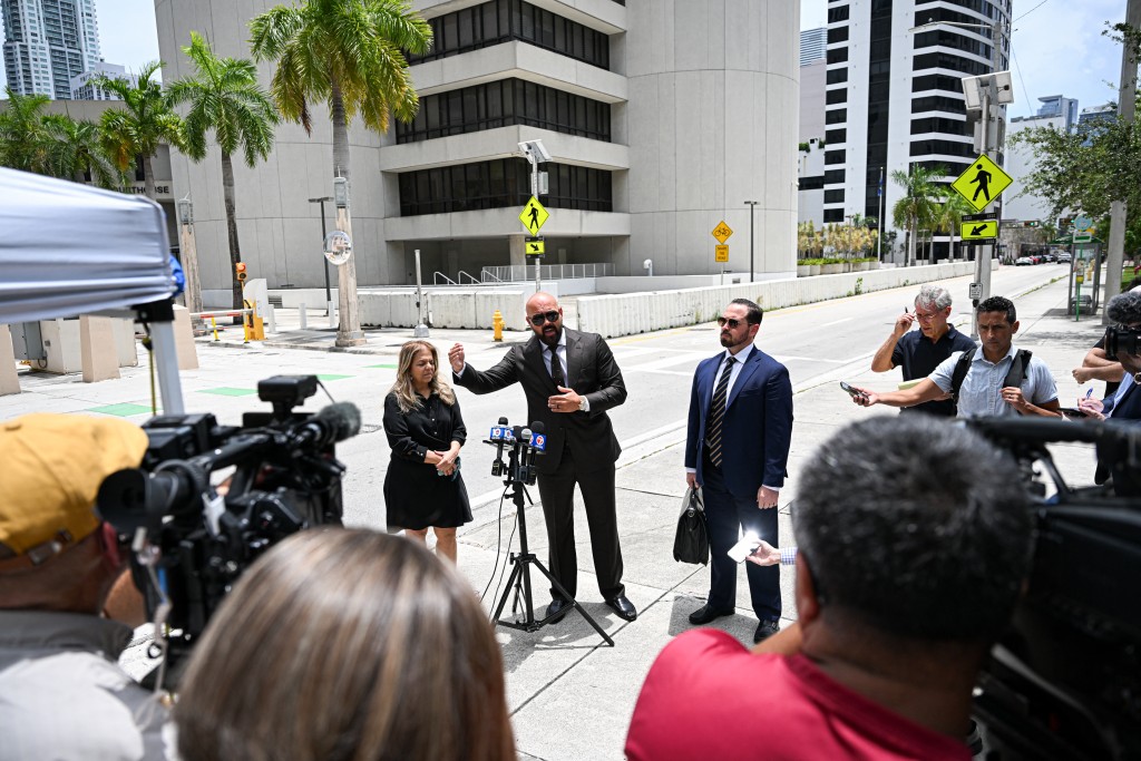 Photo by CHANDAN KHANNA / AFP Joseph D. McBride, attorney for Andrew Tate and Tristan Tate, speaks to the press following an extradition hearing for the Tate brothers at the C. Clyde Atkins US Courthouse in Miami, Florida, on July 27, 2026.