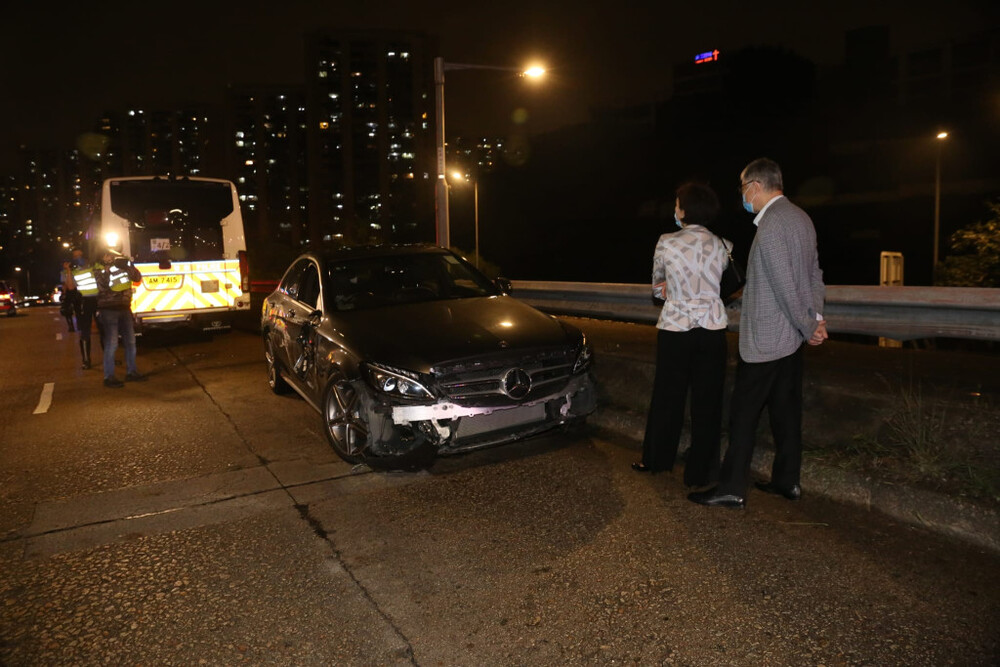 Centaline chairman Shih Wing-ching (right) and his wife helped with the investigation on site after the collision.