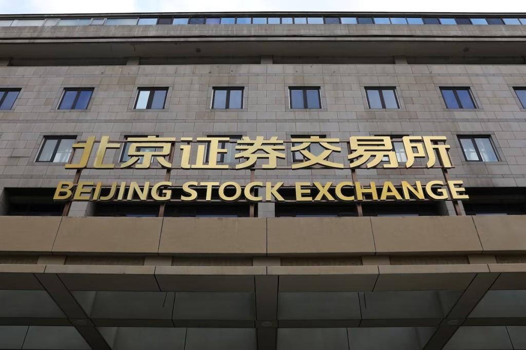The sign of new Beijing Stock Exchange is pictured on its building at the Financial Street, in Beijing, China, November 15, 2021. REUTERS