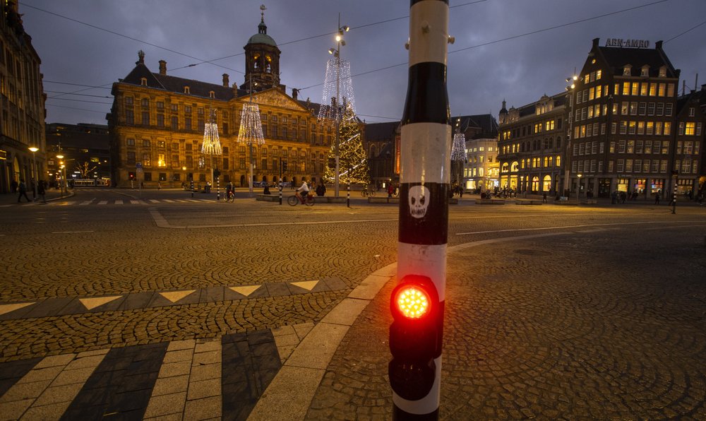 The near-empty Dam Square with the Royal Palace, seen center rear, in Amsterdam, Netherlands. The Dutch government said Wednesday, January 20, 2021, that it wants to impose a curfew to rein in the spread of new more contagious variants of the coronavirus that already accounts for at least one in every 10 Dutch infections. The near-empty Dam Square with the Royal Palace, seen center rear, in Amsterdam, Netherlands. The Dutch government said Wednesday, January 20, 2021, that it wants to impose a curfew to rein in the spread of new more contagious variants of the coronavirus that already accounts for at least one in every 10 Dutch infections.