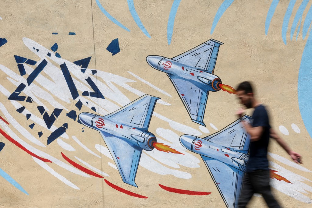 An Iranian man walks next to an anti-Israeli mural on a street in Tehran, Iran June 6, 2026. (Reuters)