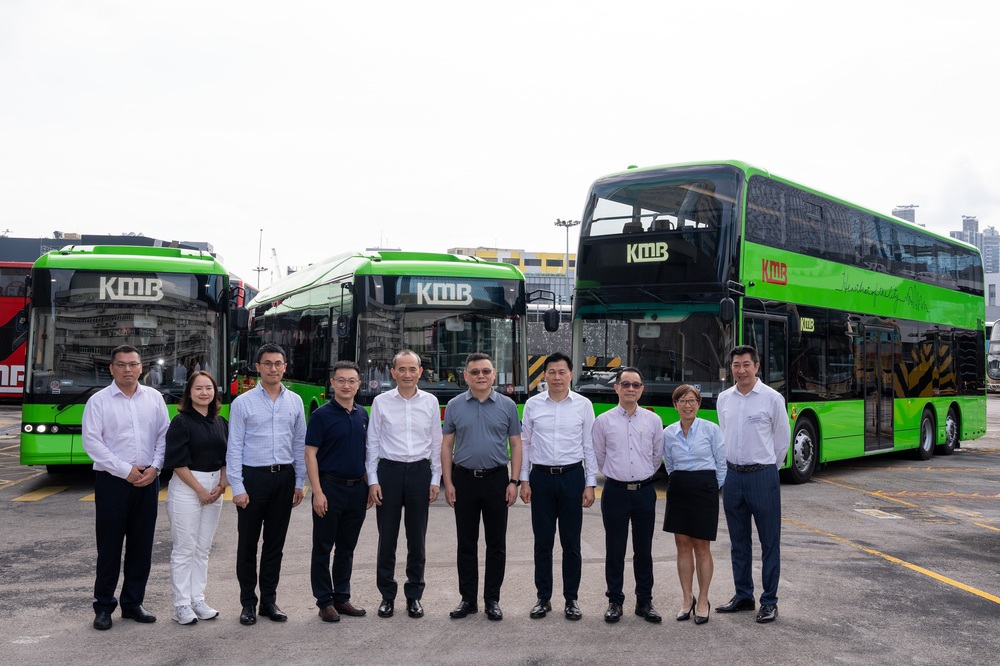 Roger Lee, below far left, seen with Tian Chunlong, says KMB is moving forward with the goal of replacing its entire 4,100-bus fleet with electric buses. SING TAO Roger Lee, below far left, seen with Tian Chunlong, says KMB is moving forward with the goal of replacing its entire 4,100-bus fleet with electric buses. SING TAO