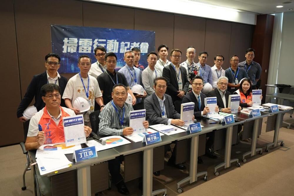 Edward Leung, seated fourth from left, with building inspectors. Edward Leung, seated fourth from left, with building inspectors.