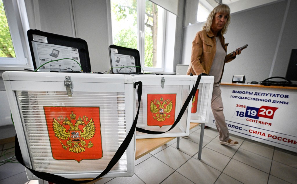 Photo by ALEXANDER NEMENOV / AFP A member of a local electoral commission inspects a polling station ahead of the upcoming election to the Russian State Duma (lower house of Russia's Parliament) in central Moscow on September 17, 2026.