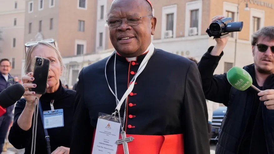 FILE – Cardinal Fridolin Ambongo Besungu arrives for a college of cardinals’ meeting, at the Vatican, Wednesday, April 30, 2025. (AP Photo/Gregorio Borgia, File)